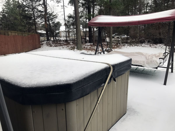 hot tub covered in icy snow